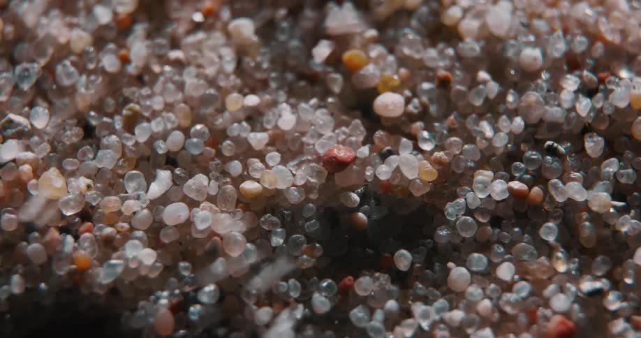 Grains of sand are blown away