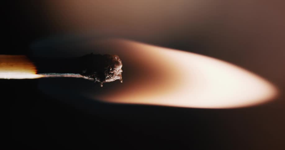 Match sparks and starts to burn and char