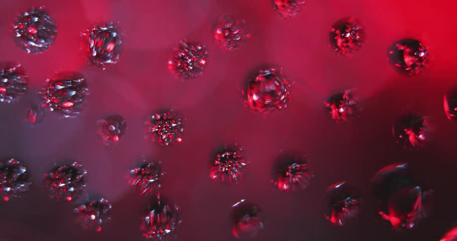 An up close of water droplets with colors in the background