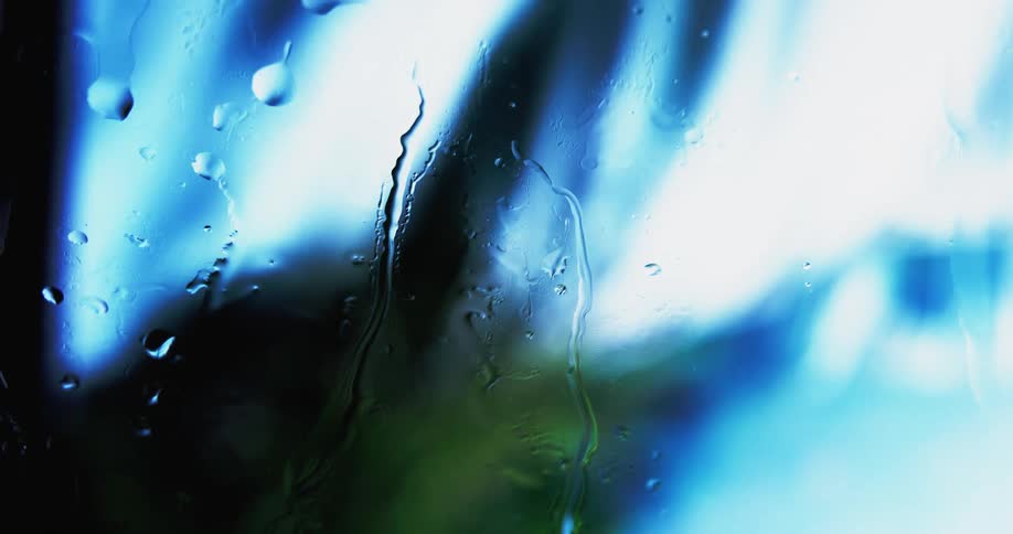 Water drips down camera lens as blue flows