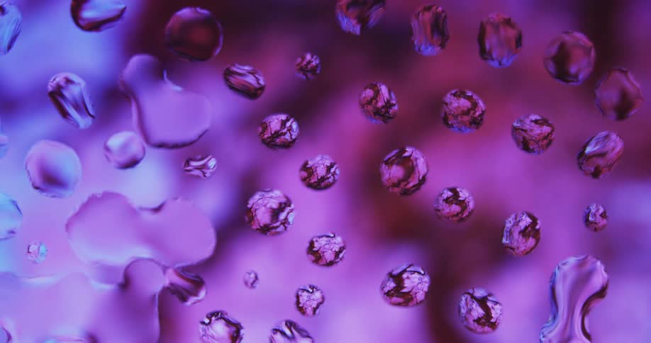 Water droplets spread out on a mirrored surface