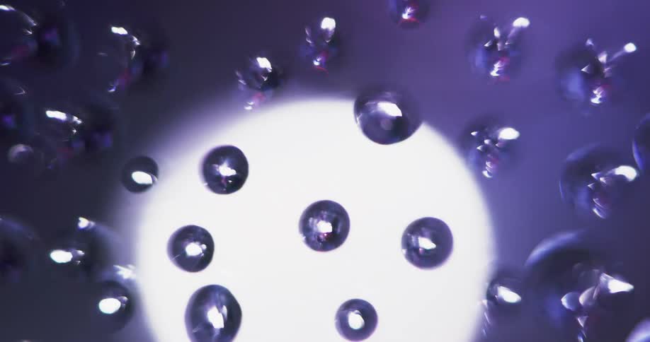 An up close of a light behind glass reflecting off little circles