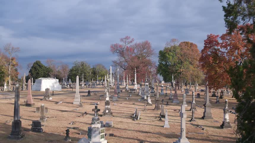 A cemetery is filled with tombstones
