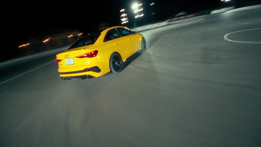 Yellow racing car drifting on a racing course at night
