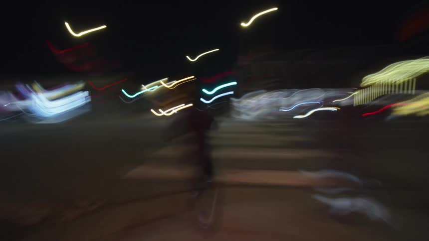 A man walking through the city at night