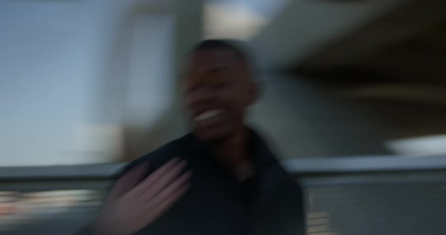 A man and woman smiling at each other then another woman walks up to the man