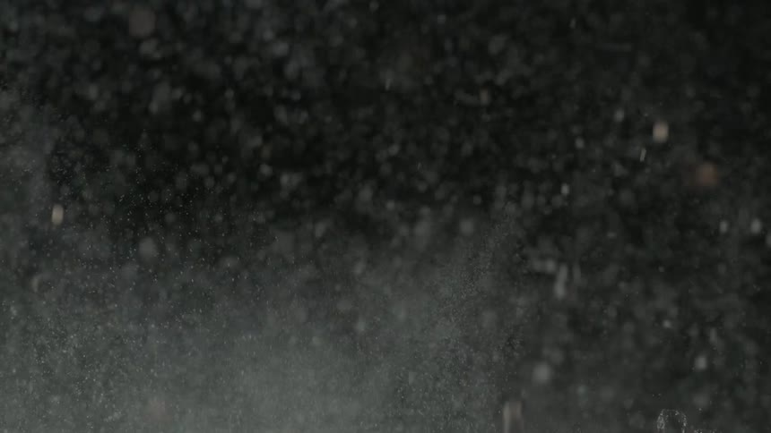 Water splashing into the air with a dark background