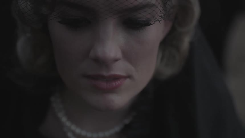 A woman wearing lace mourns