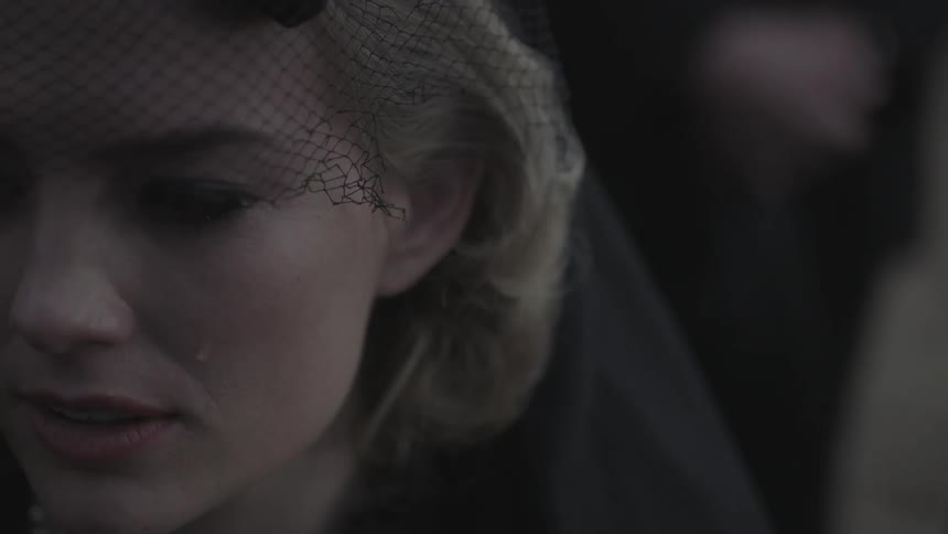 A woman in a veil cries