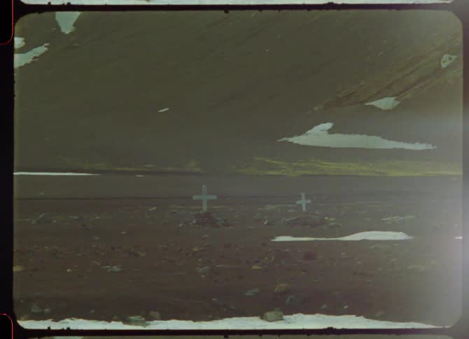 Snow and rocks are scattered along the roadside