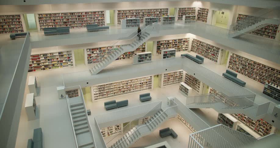 The view is of a building and someone is walking down the stairs