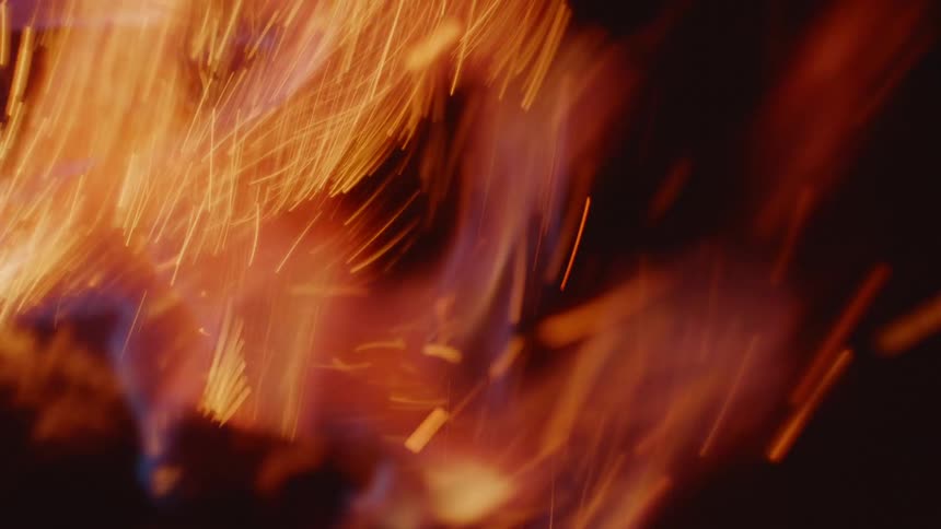 Fiery Spectacle: Object with Blue Flame Engulfed by Orange Flames with Spark Showers