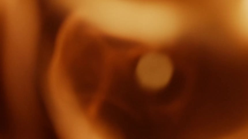 Interior of a tube is blasted from outside with a flame explosion that comes rushing into the tube and fills frame with flames