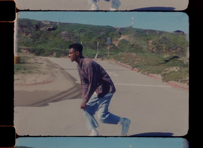 A young teenager is skate boarding outside in the day time