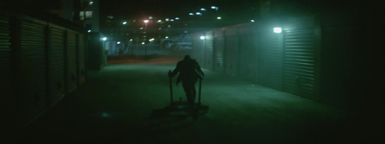 A man pushes a pallet past the storage lockers