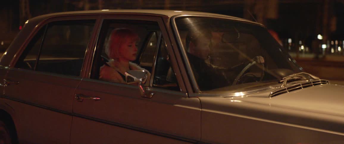 Man and woman are driving a car during the night time