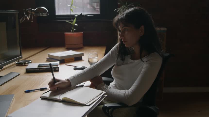 A young woman is working in the office in the day time