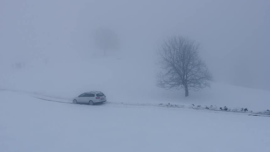 Winter Storm Drive: Car Navigating Snowy Road