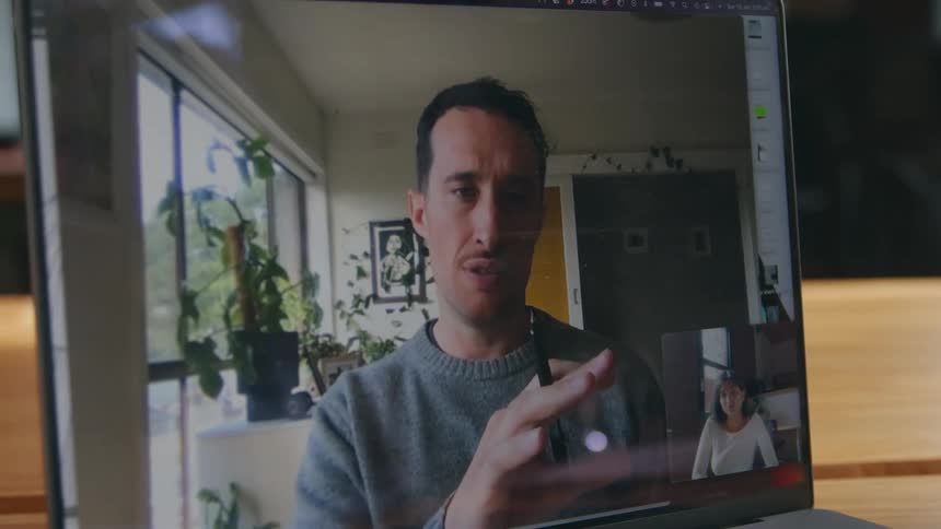 A man and woman are having a meeting online via computer