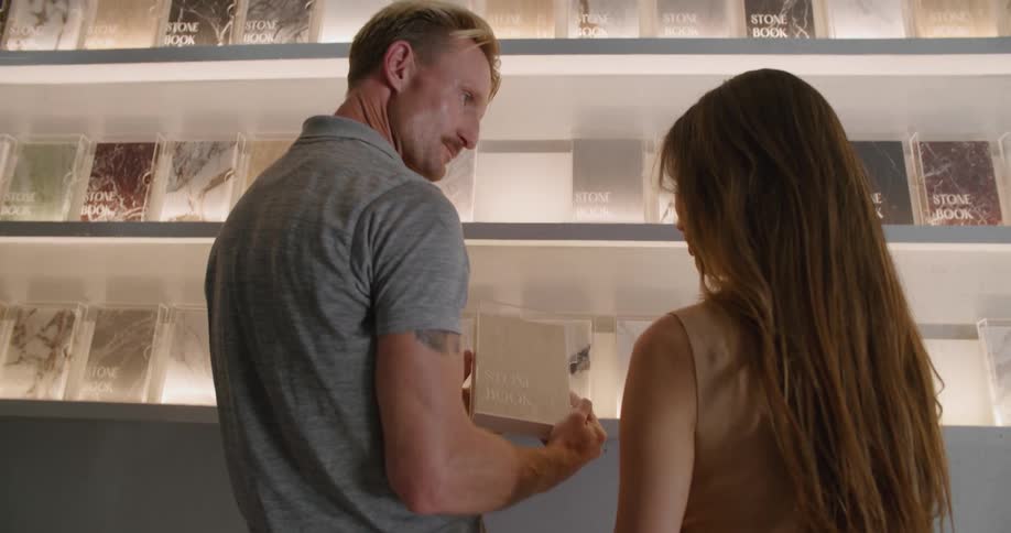 A woman and male looking at marble