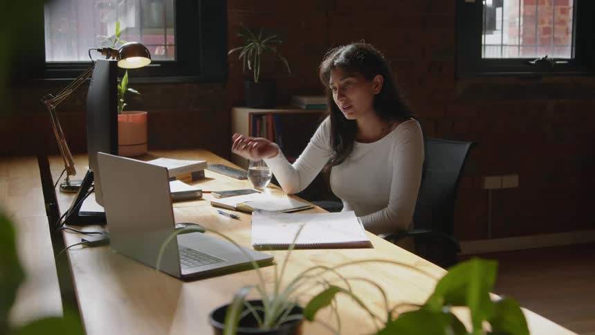 A young woman is working into the office in the middle of the day