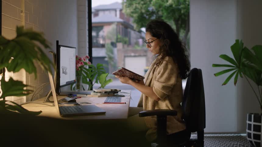 A woman working on a project on her desktop computer