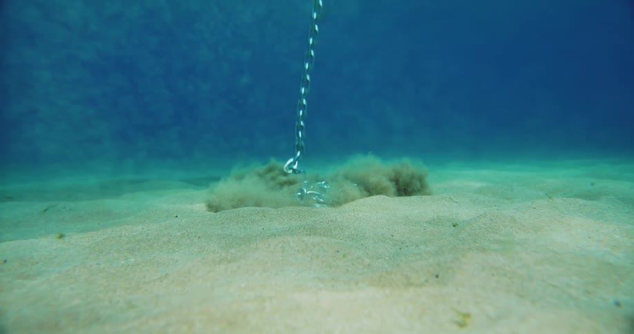 A chain falling down into the water