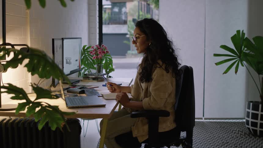 A young woman is working inside of an office in the day time