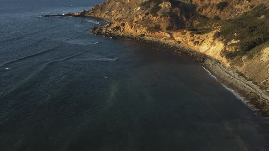 An aerial of a coastline with mountains