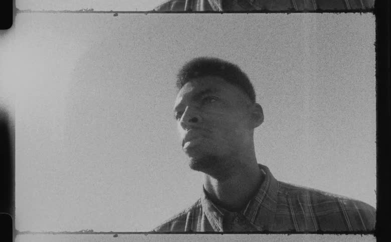 A filmstrip of a young black man looking off in to the distance and then turning his head