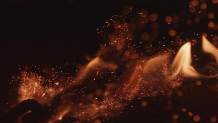 Close up view of a fire and ash is displayed
