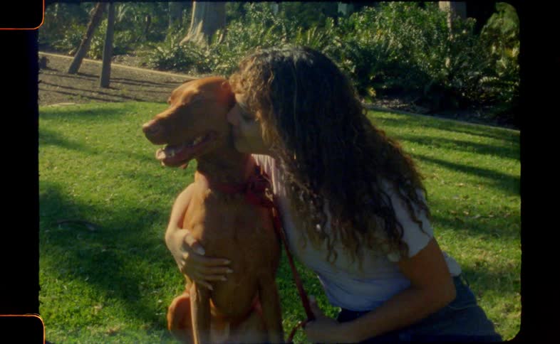 A woman kisses her dog