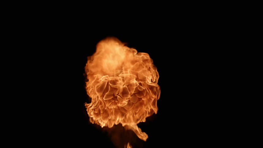 A fire bomb explodes in a dark room