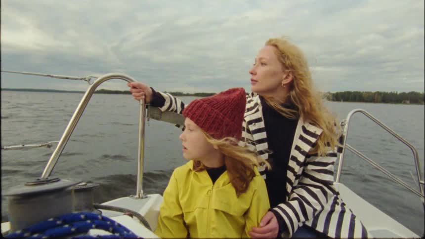 A woman riding her boat with her child