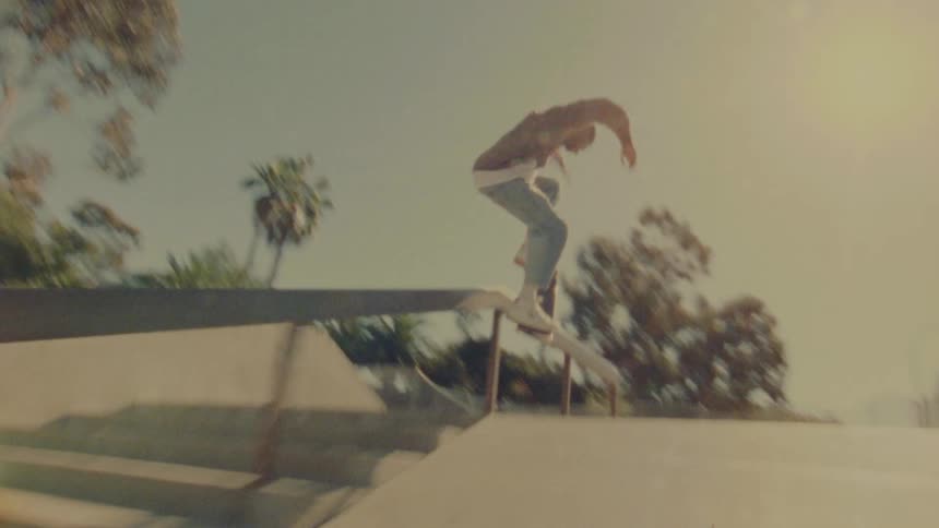A teenager is skateboarding in the park