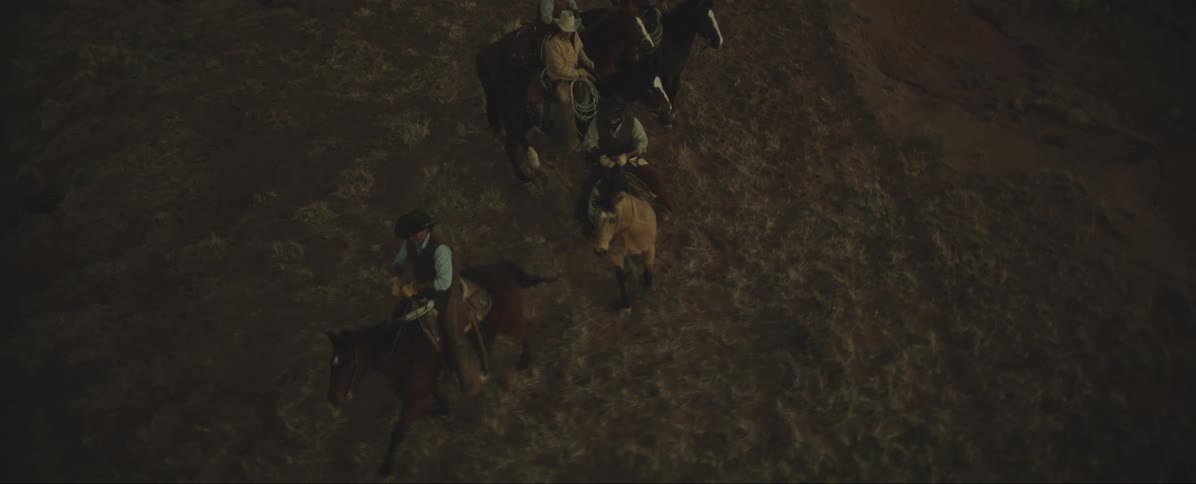 Cowboys riding horses