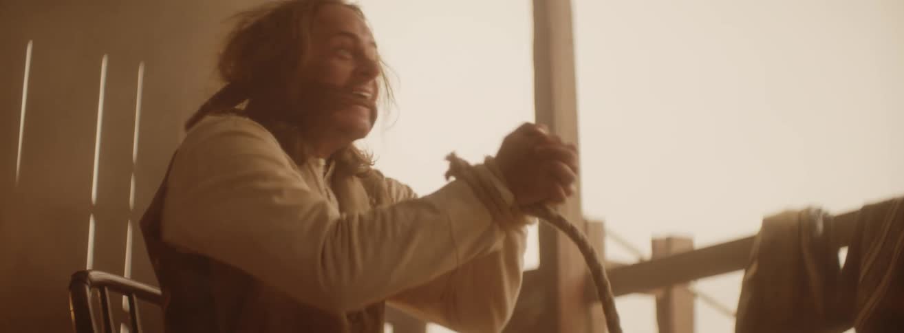 A man is tied up and struggling