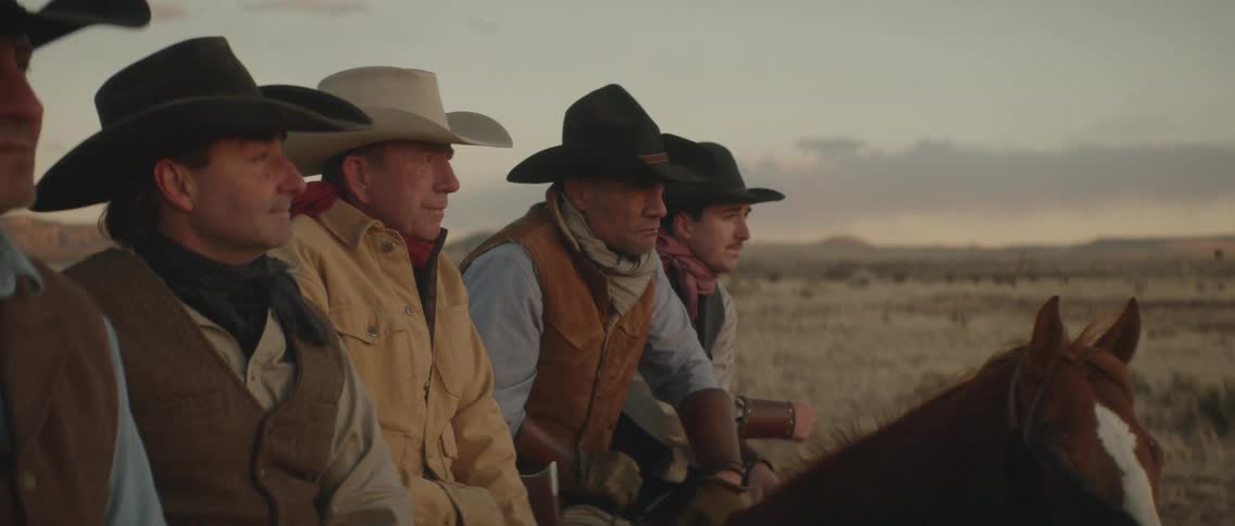 A group of men in cowboy hats on horses standing in a group