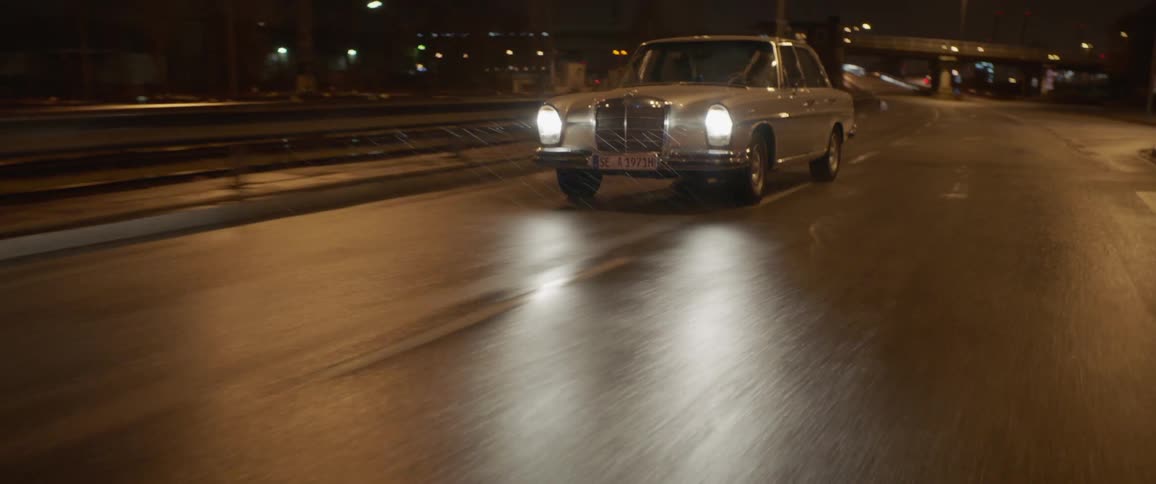 A person is driving a vehicle on a highway at night time