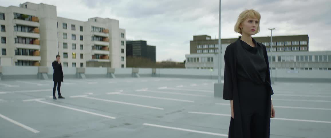 Woman and man are standing in a downtown city