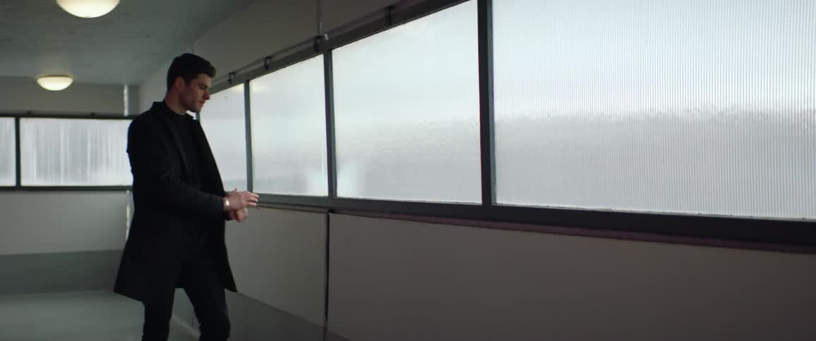 A man is walking through a building and looks upset