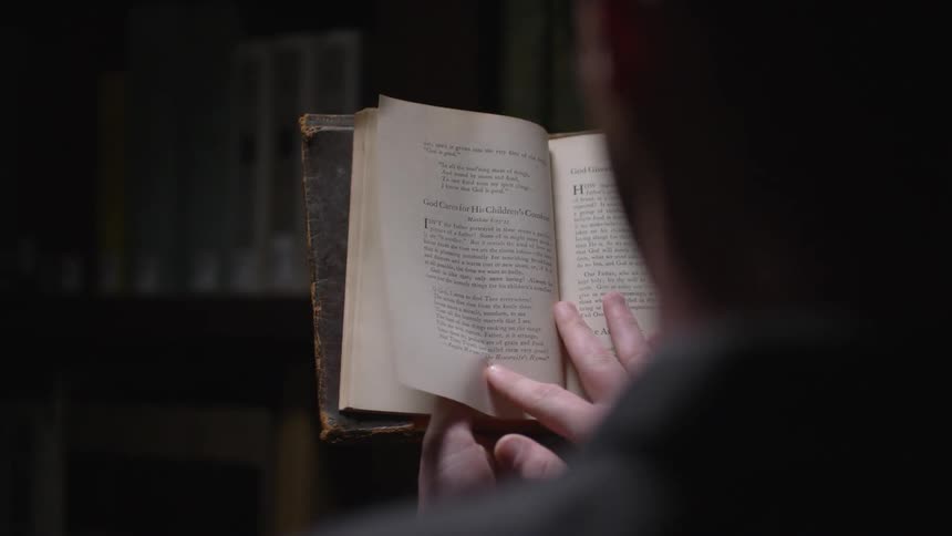 A man is flipping through a book