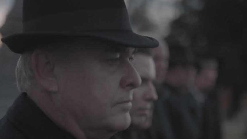 A row of men wearing black