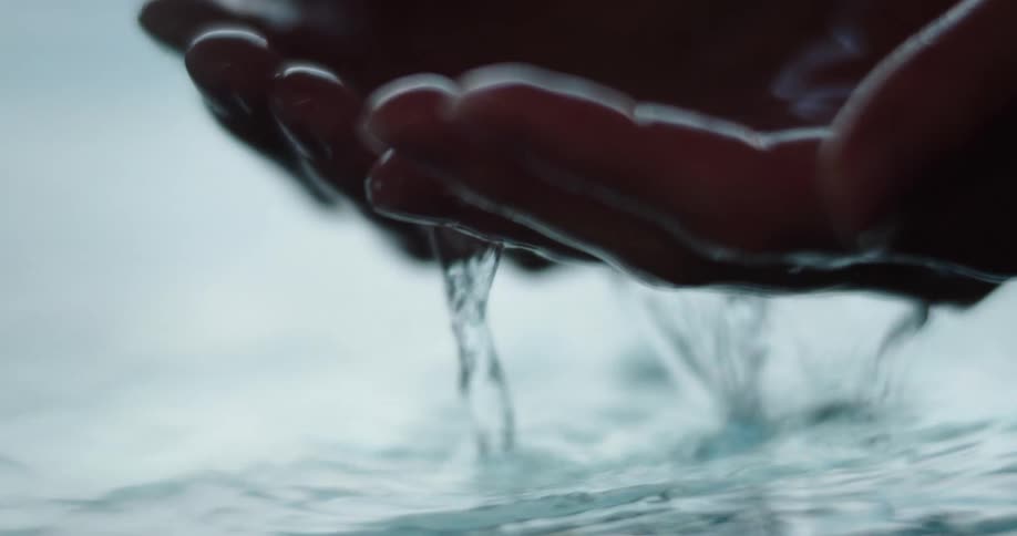 Womans cupped hands taking water
