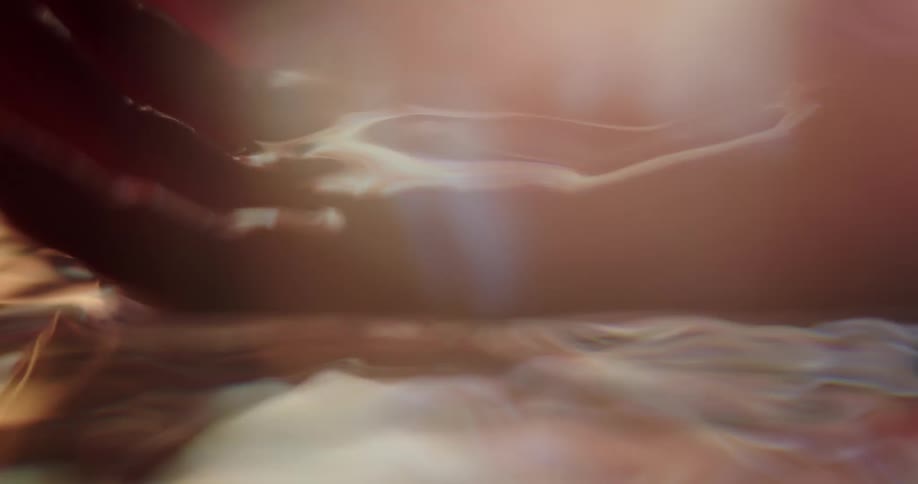 A person dipping their hands in water