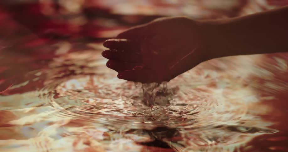 Close up of cupped hand taking water