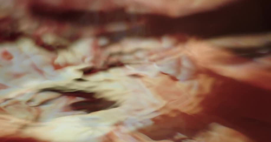 Close up of a hand creating small ripples and waves on the surface of a body of clear water