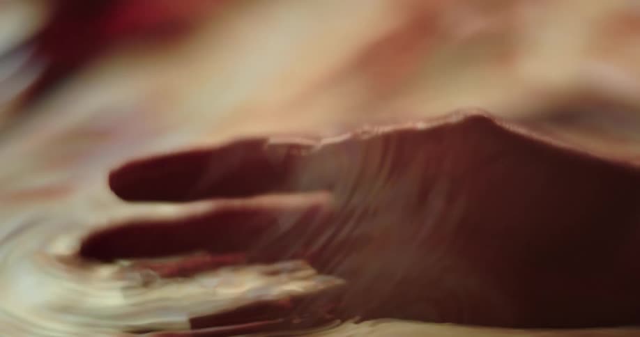A person dipping their hands in water