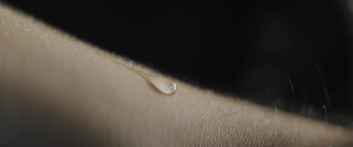 A close up of sweat rolling