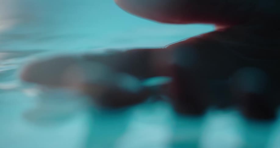 A woman swims in chest high pool water